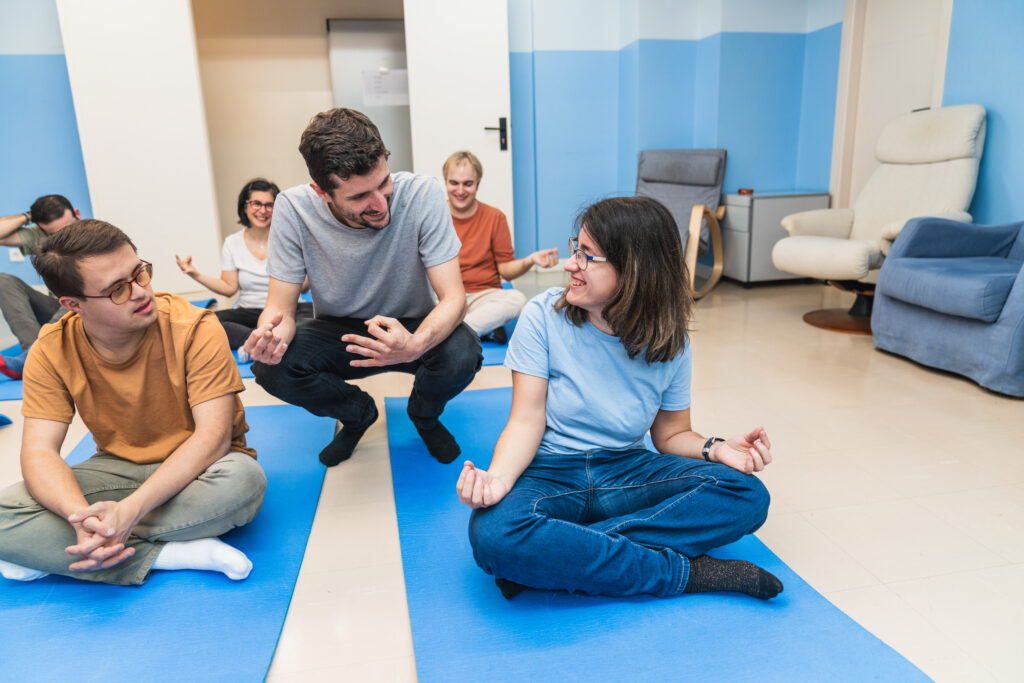 An engaging group yoga session, including a participant with Down Syndrome